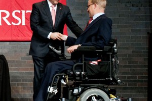 Travis Accepts Award